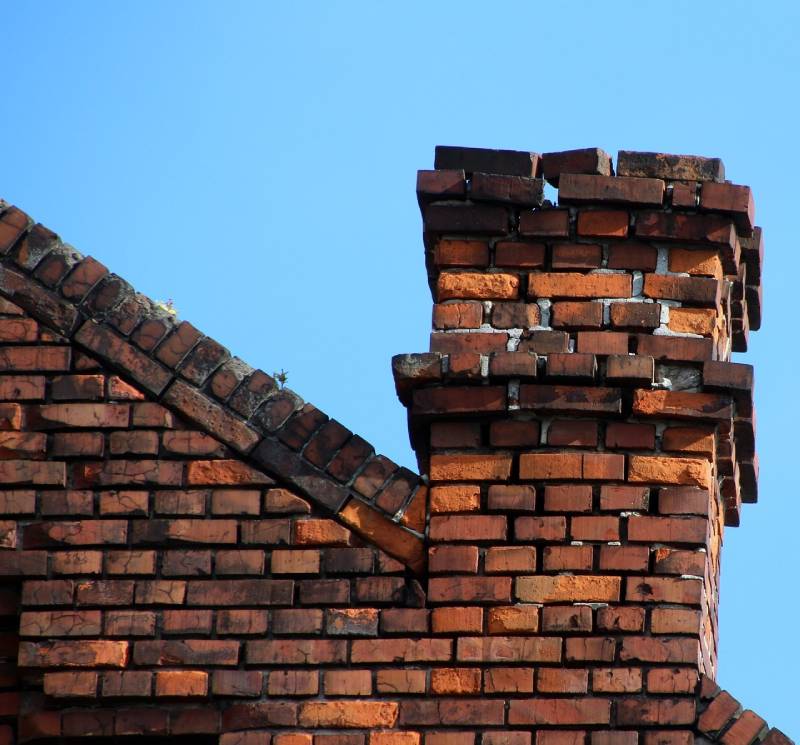 Signs Your Fitchburg Home Needs a Chimney Inspection Damaged chimney on an Fitchburg home showing cracks and missing mortar